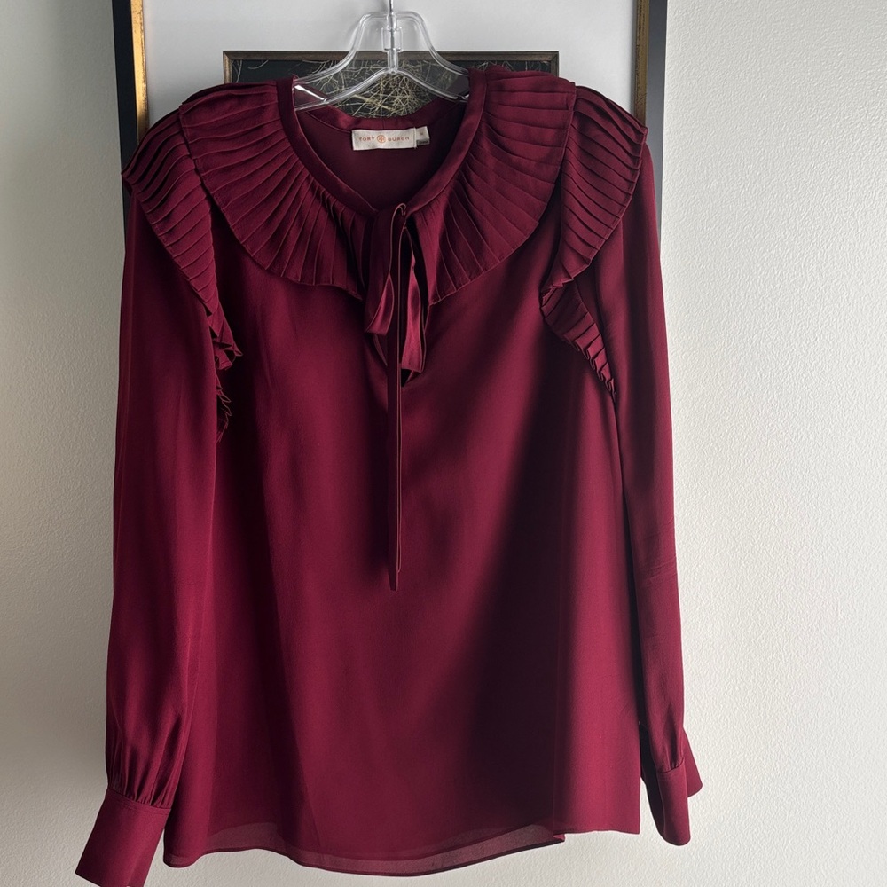 Tory Burch v-neck blouse with beautiful ruffle trim at the neck and shoulder.